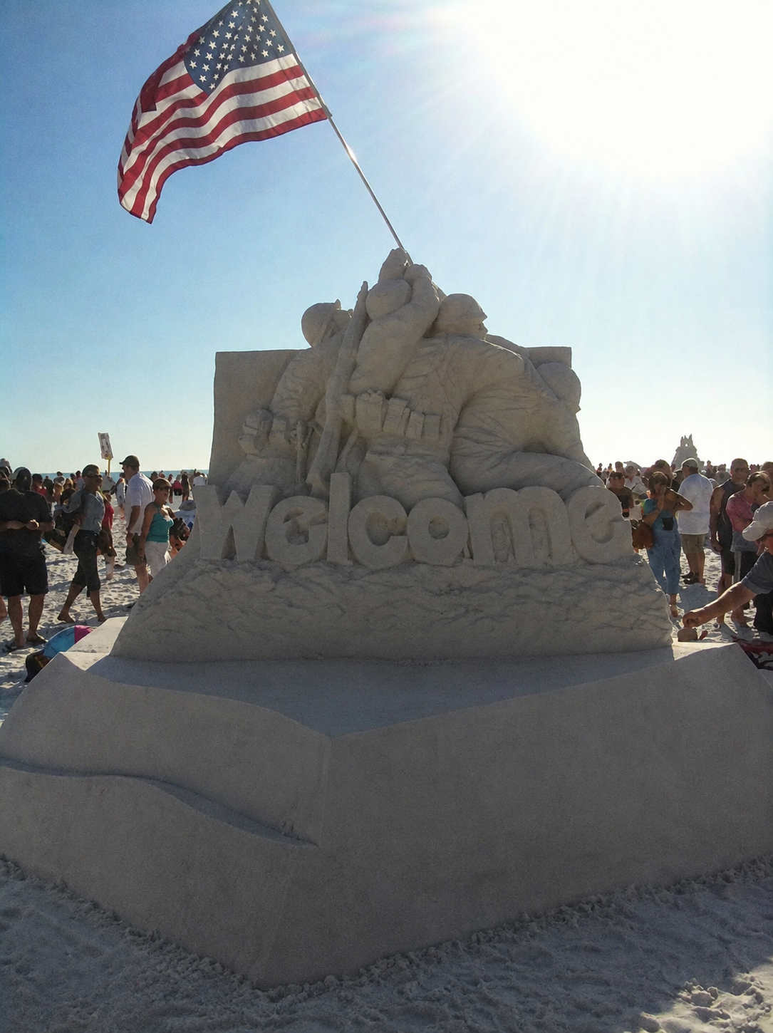 Welcome sand sculpture with an American flag on Siesta Key
